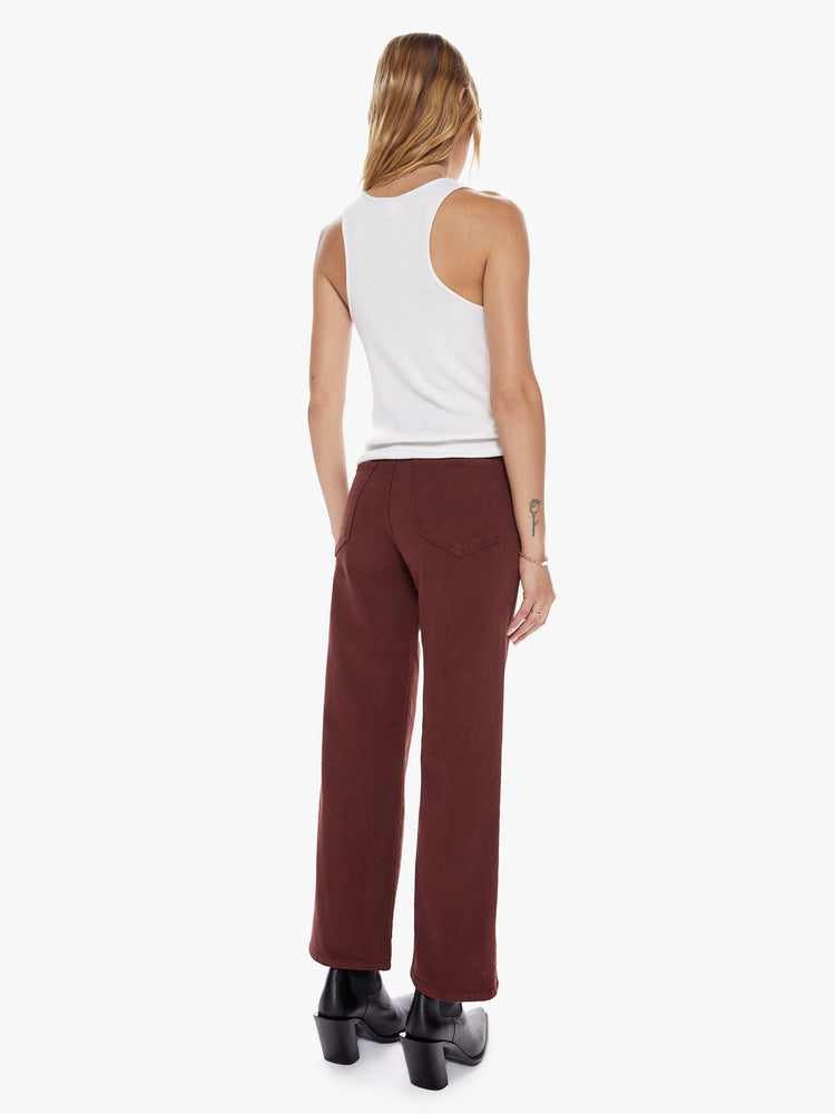 Back view of a womens brown burgundy high waisted wide straight leg pant with an ankle length inseam and button fly.
