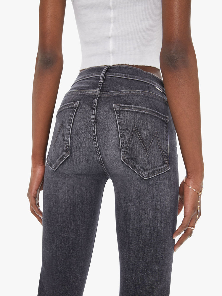 Back close up view of a womens faded black wash jean featuring a mid rise, straight leg, and ankle length hem.