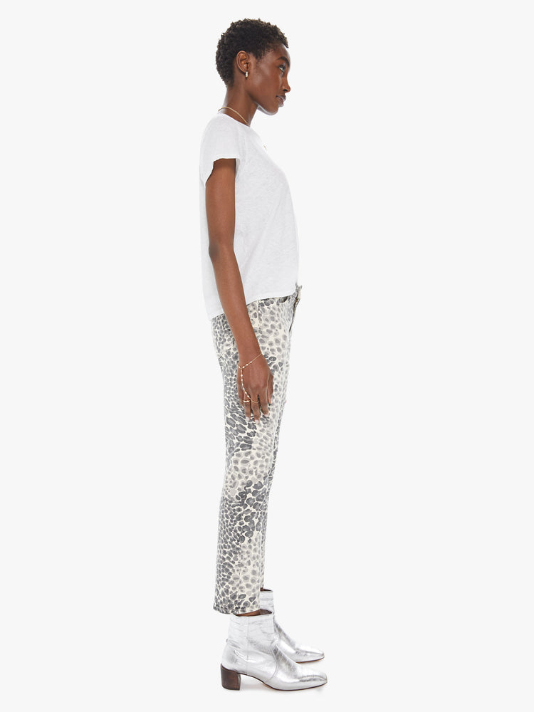 Side view of a women's ivory and grey leopard print mid rise jean with a slim straight fit and an ankle length inseam
