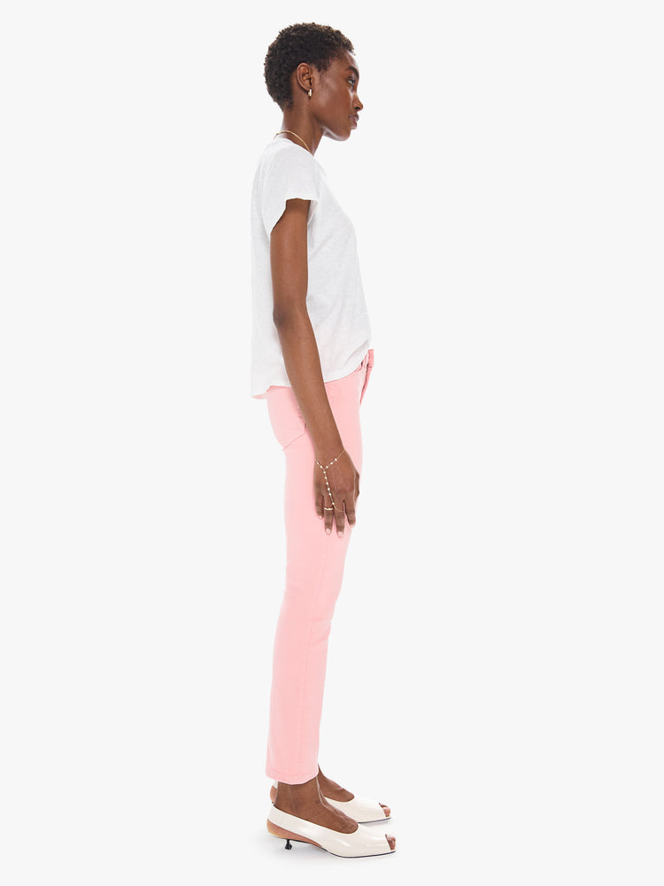 Side view of a women's light pink mid rise jean with a slim straight fit and an ankle length inseam