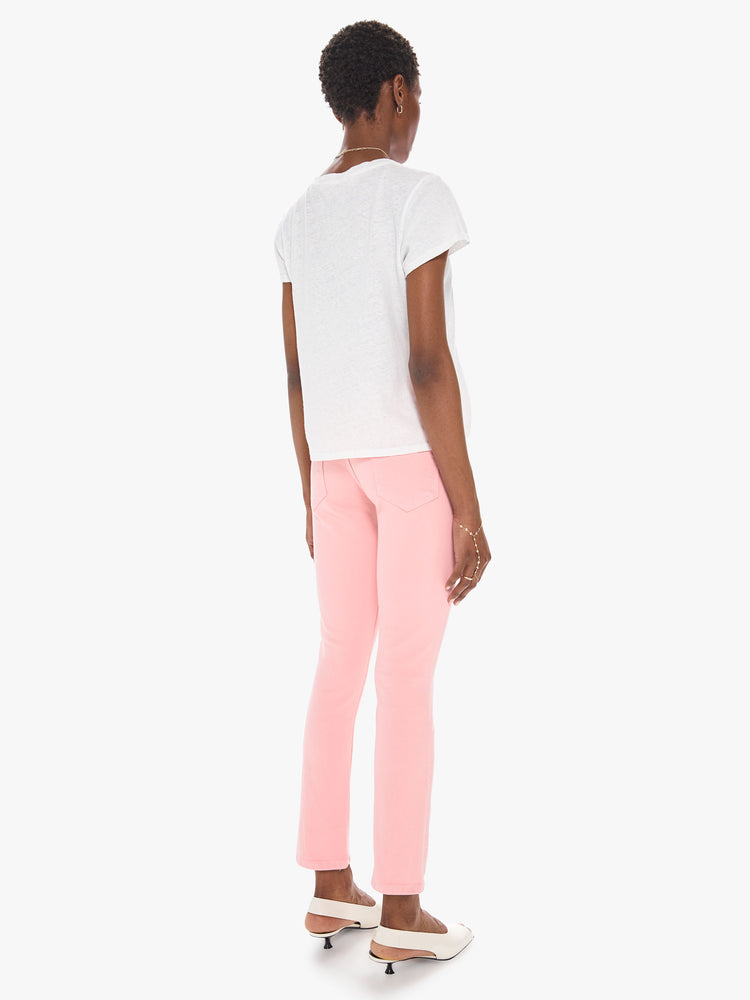 Back view of a women's light pink mid rise jean with a slim straight fit and an ankle length inseam