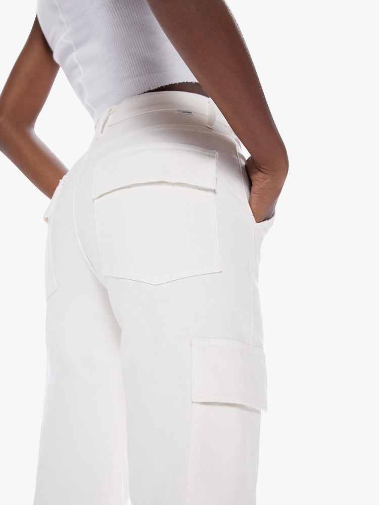 Close up back view of a woman High-waisted ankle-length pants with a wide straight leg, cargo pockets and seams down the front in an off white hue.