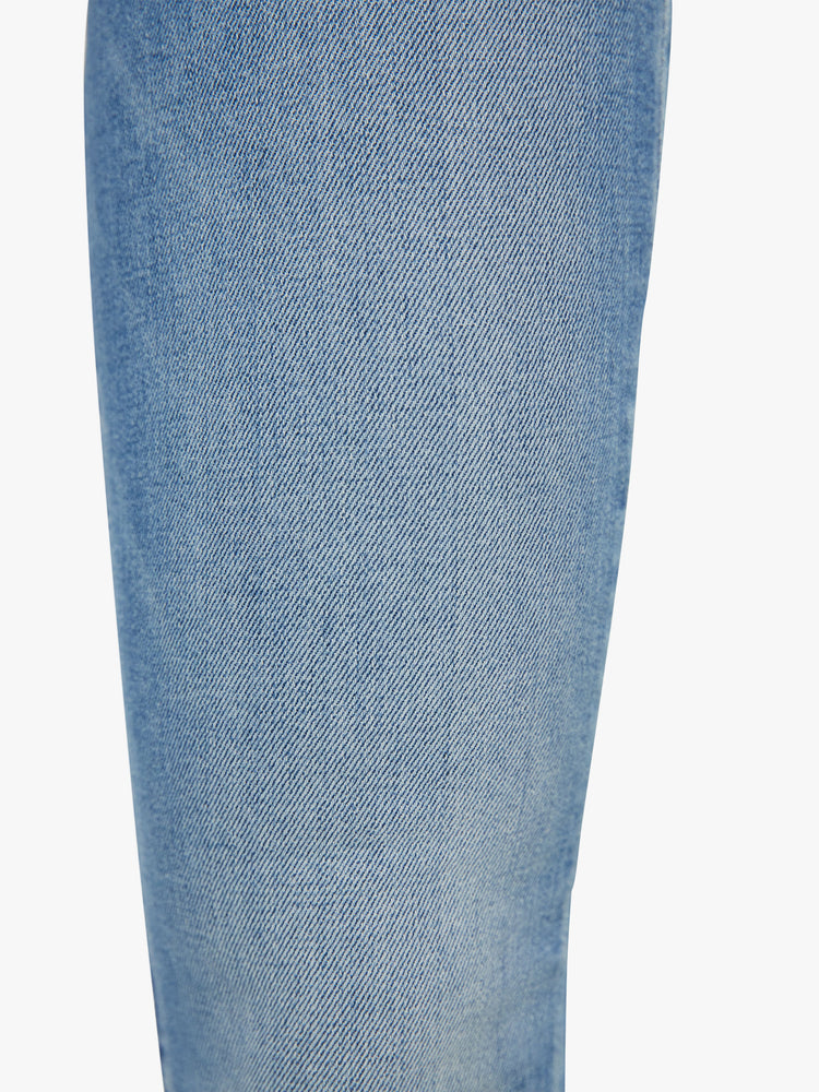 Close up view of a womens medium blue wash jean.
