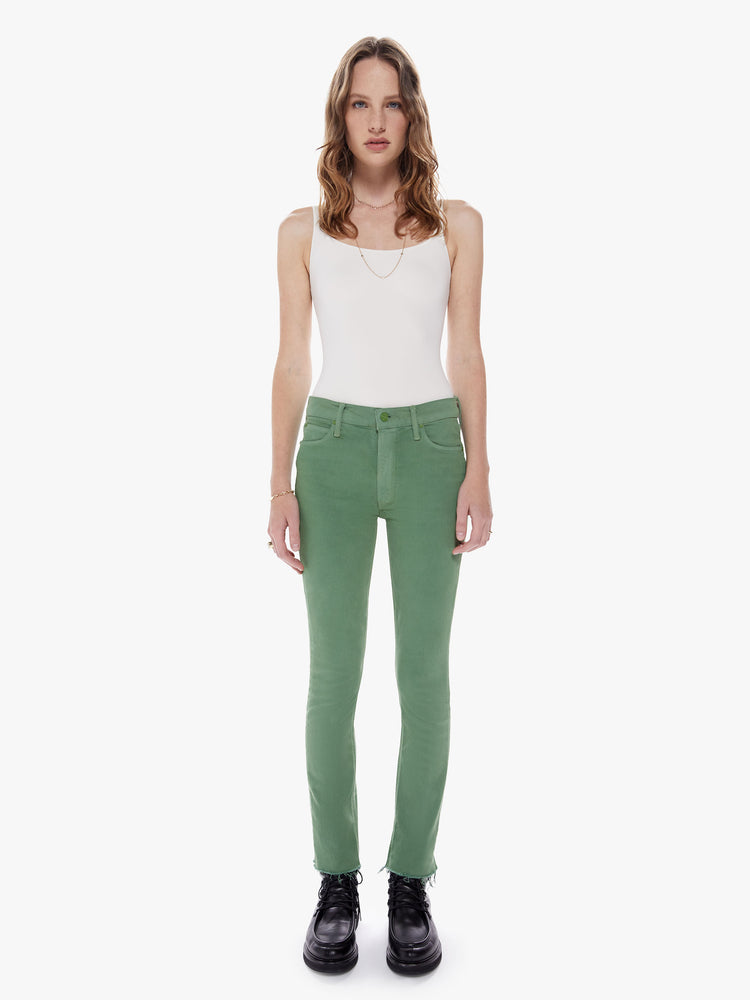 Front full body view of a mid rise straight leg with an ankle inseam and a frayed hem cut from stretch cotton fabric in a green hue with tonal hardware for a monochrome look