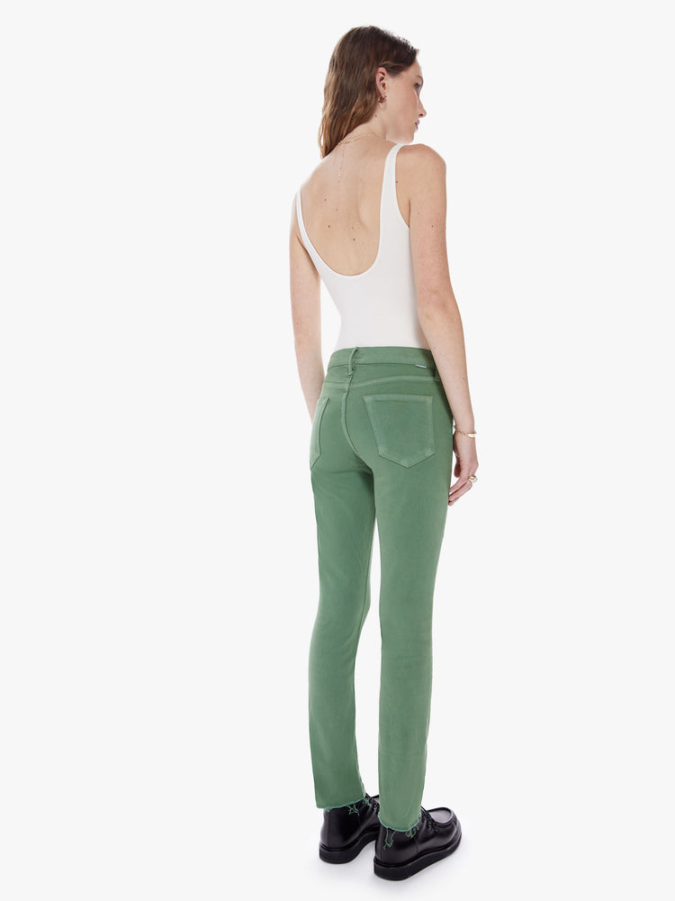 Back full body view of a mid rise straight leg with an ankle inseam and a frayed hem cut from stretch cotton fabric in a green hue with tonal hardware for a monochrome look
