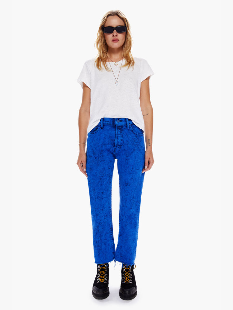 Front full body view of a woman in a cropped jean with a button fly, slouchy straight leg and relaxed fit that's designed to sit on the hips cut from denim with a touch of stretch in a bright blue hue with acid-washed details