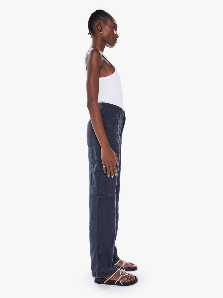 Side view of a woman's High-waisted cargo pants with a wide straight leg, patch pockets and a clean 32-inch inseam in a faded black.