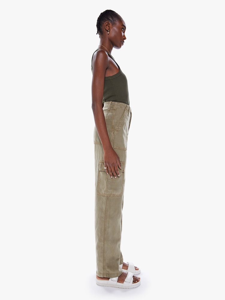 Side view of a woman's High-waisted cargo pants with a wide straight leg, patch pockets and a clean 32-inch inseam in an olive green hue.