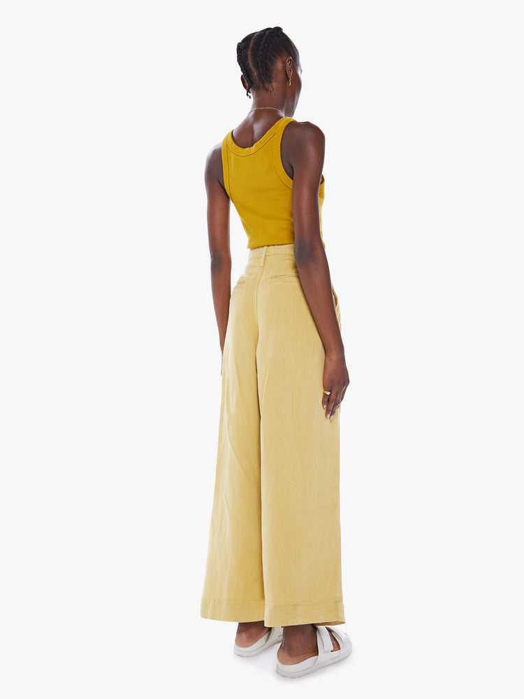 Back view of high-waisted wide leg pant with a pleated waistband, back slit pockets, an ankle-length inseam and a clean, thick hem in a sunny yellow hue.