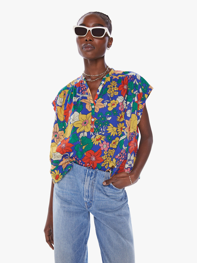 Front view of a woman's blouse with a buttoned V-neck, rolled short sleeves, a boxy fit in floral print.