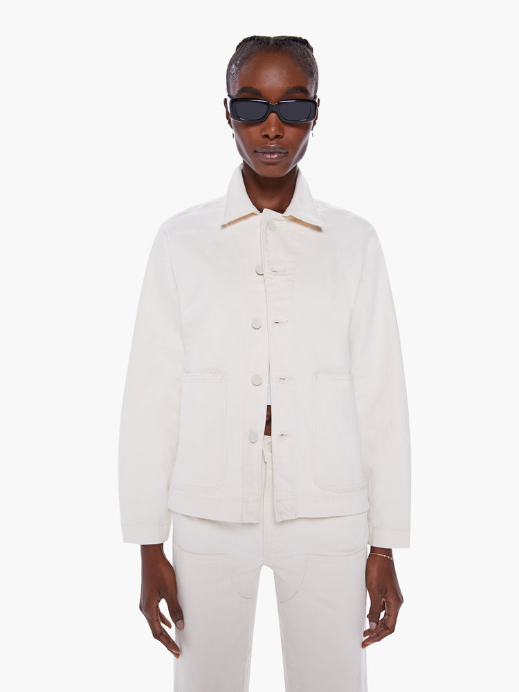 Women's denim jacket with oversized front patch pockets, cropped long sleeves and a boxy fit in a creamy white hue.
