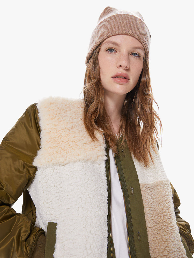 Front detail of a women's army green jacket with sherpa patchwork