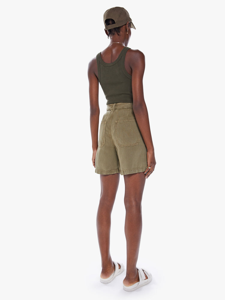 Back view of a woman High-waisted paperbag shorts with a tied waist, oversized patch pockets in an olive green hue with faded details.