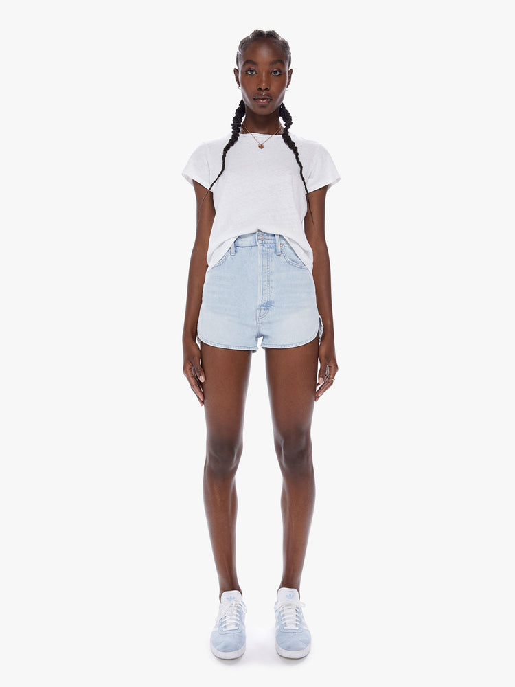 Front view of a woman Ultra high-waisted denim shorts with a button fly and a curved side seam in a light blue wash made from semi-rigid SUPERIOR denim.