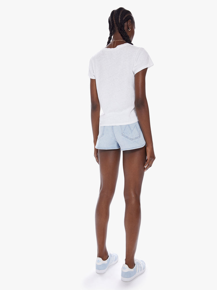 Back view of a woman Ultra high-waisted denim shorts with a button fly and a curved side seam in a light blue wash made from semi-rigid SUPERIOR denim.