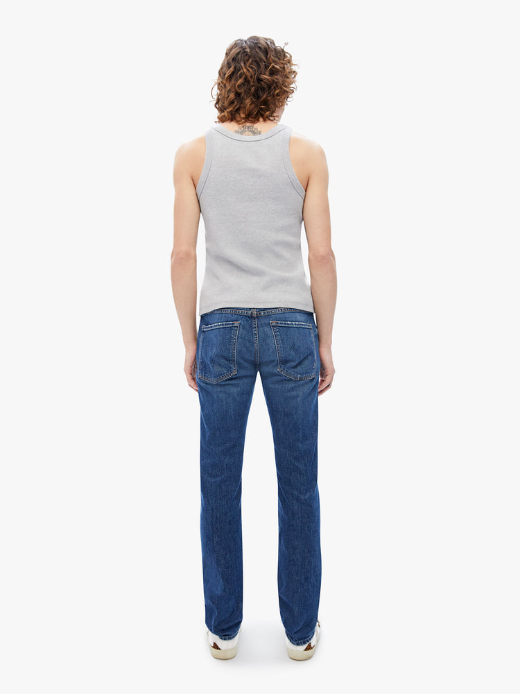Back view of men slim-straight leg with a mid rise, 32-inch inseam and a clean hem in a dark blue wash