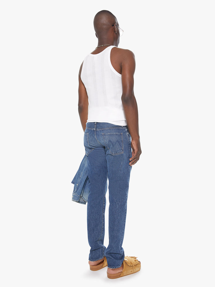 Back view of a men's medium blue straight leg jean with fading and whiskers