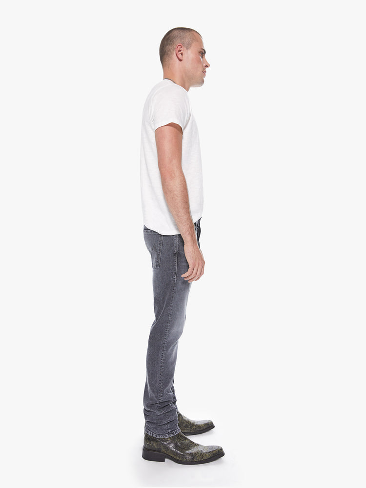 Side view of a men's grey straight leg jean with fading and whiskers