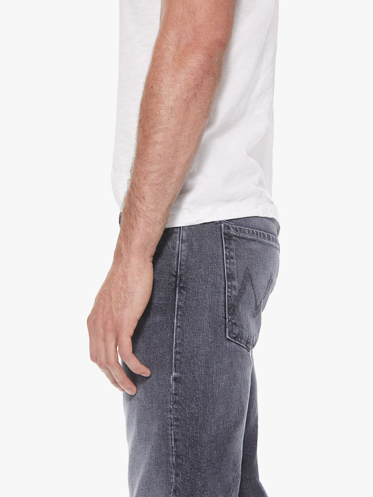 Side detail view of a men's grey straight leg jean with fading and whiskers