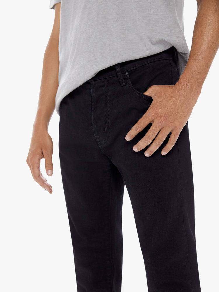 Pocket detail view of a men's black slim-straight jean