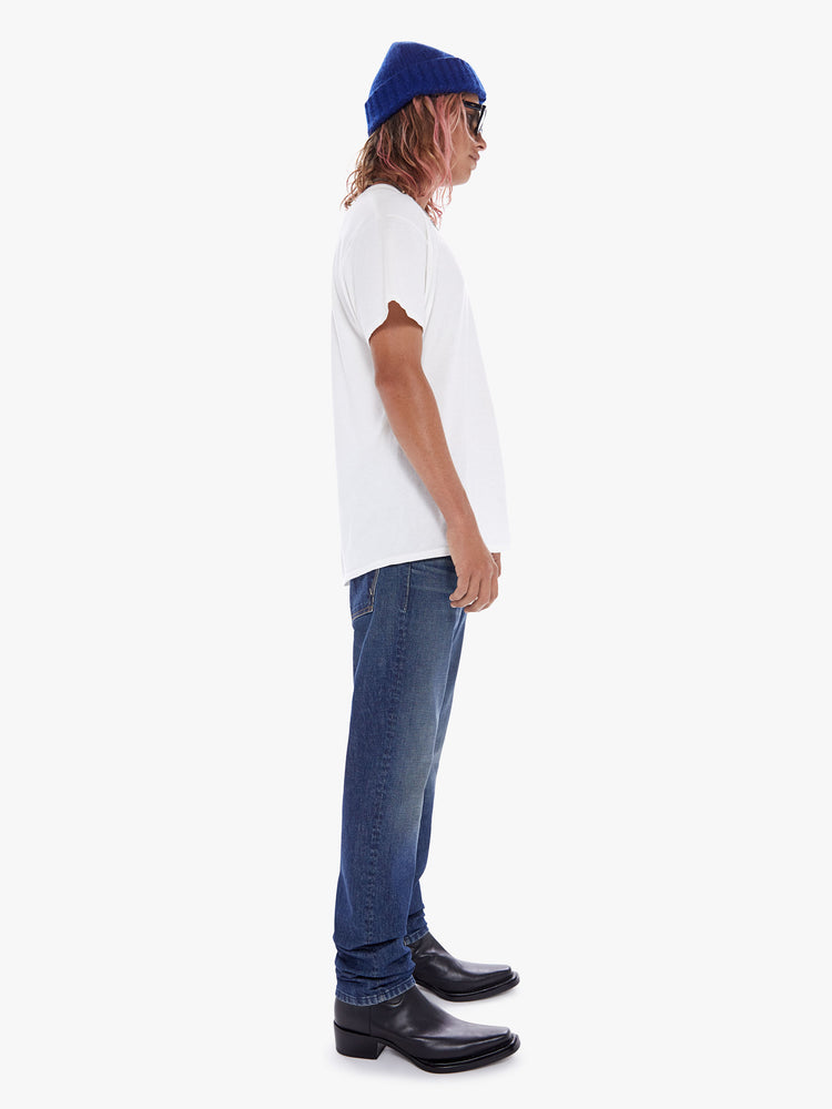 Side view of a men's medium blue slim-straight jean with subtle fading and whiskering