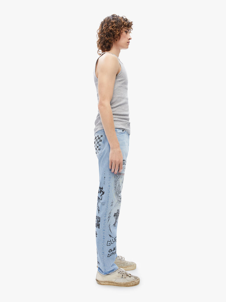 Side view a mens mid-rise straight leg with a 32-inch inseam and a clean hem in a light-blue wash with subtle whiskering, fading and angsty, hand-drawn doodles in black and red.