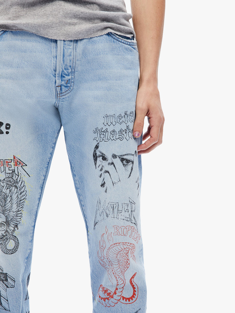 Close up view a mens mid-rise straight leg with a 32-inch inseam and a clean hem in a light-blue wash with subtle whiskering, fading and angsty, hand-drawn doodles in black and red.