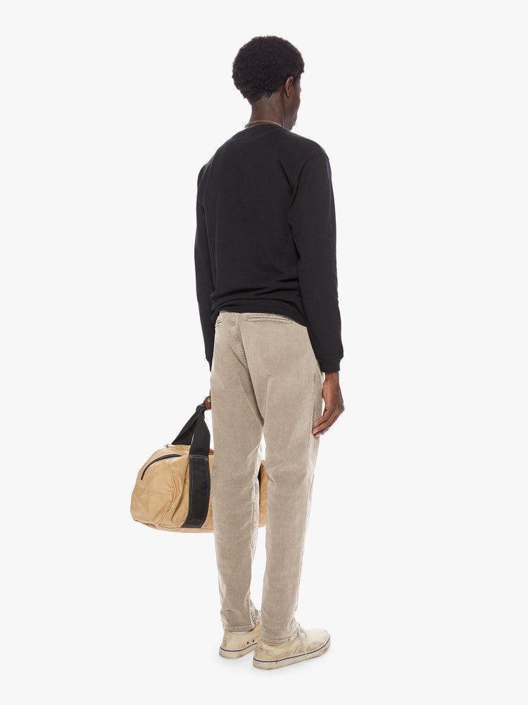 Back view of a man wearing a beige straight leg pant
