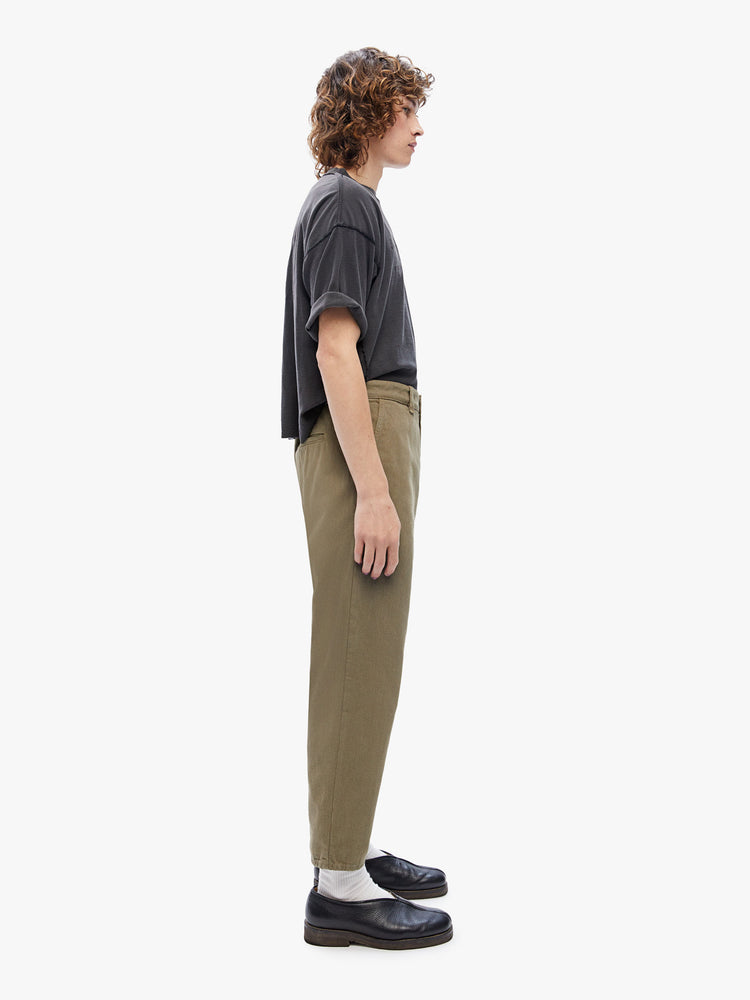 Side view of mens straight, slightly tapered leg, ankle-length inseam and slash pockets pant in an army green hue
