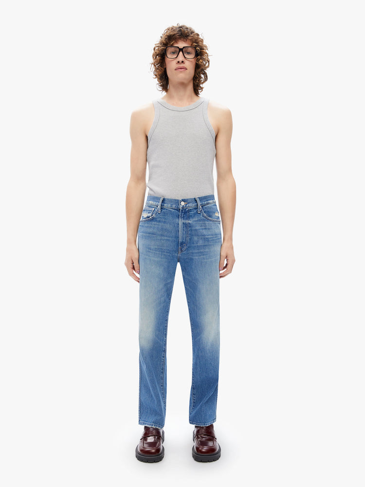 Front view of a men's  straight-leg jean with a mid rise, ankle-length inseam and a clean hem in a mid blue wash with subtle whiskering,fading and distressed details