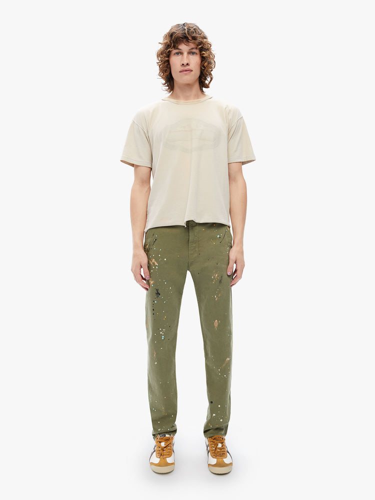 Front view of a mens classic pant with utilitarian pockets, a hammer loop and relaxed leg in an army green hue with paint splatters and tonal hardware.