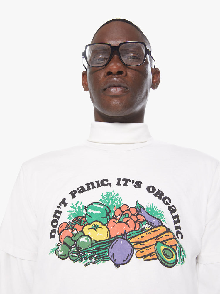Front detail view of a men's white t-shirt with a multi-colored graphic of vegetables and "Don't Panic It's Organic" printed in black font