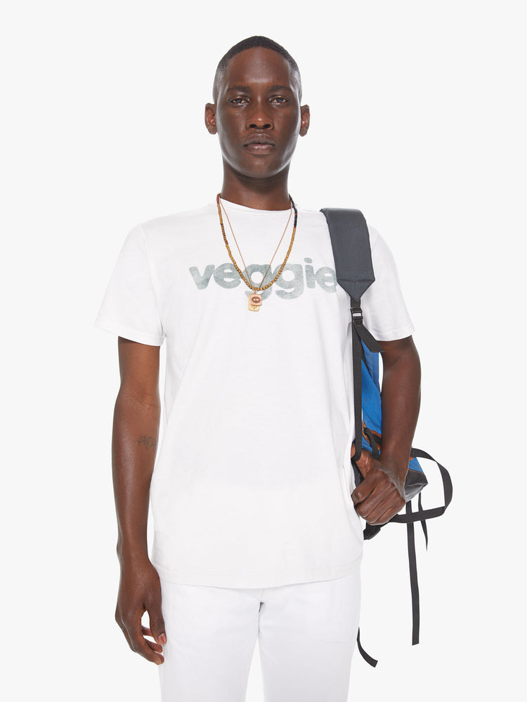 Front view of a men's white t-shirt with "veggie" printed in faded green lettering