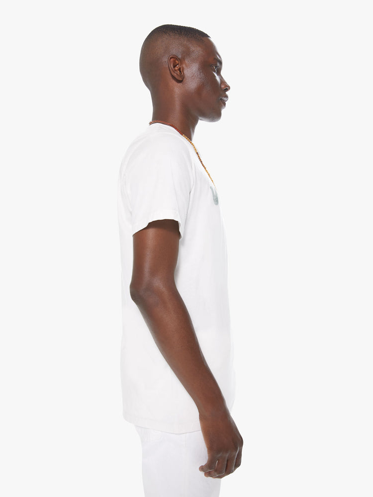 Side view of a men's white t-shirt with "veggie" printed in faded green lettering