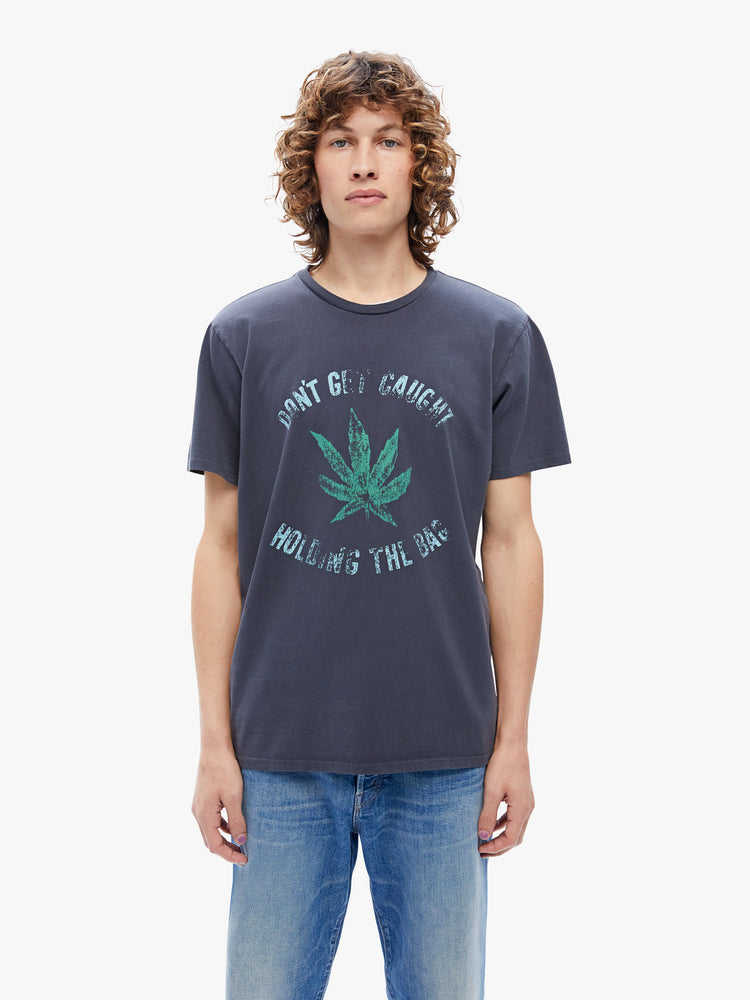 Front view of a mens classic crewneck tee with short sleeves and a boxy fit, n black, the tee features a faded weed leaf graphic and some advice from MOTHER on the front.