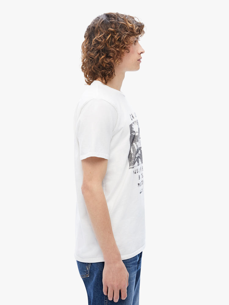 Side view of a mens classic crewneck tee with short sleeves and a boxy fit in white, the tee features a faded festival-inspired graphic on the front.