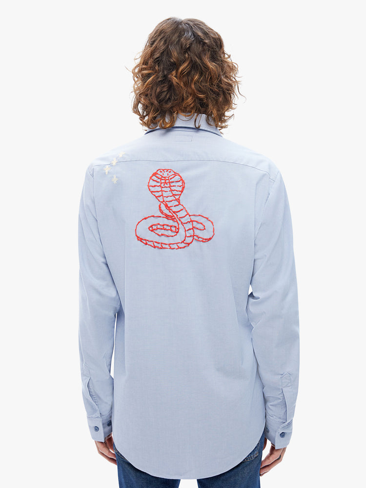 Back view of a mens long-sleeve button-up with front patch pockets and a curved hem in a light blue hue with embroidered details on the front and back.