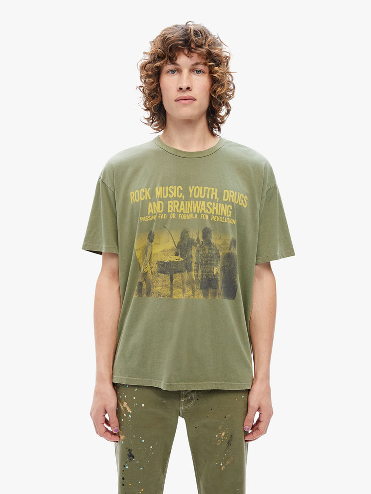 Front view of a mens oversized tee with drop shoulders and a loose fit made from 100% supima cotton in an army-green hue featuring  yellow 70s-inspired graphic on the front.