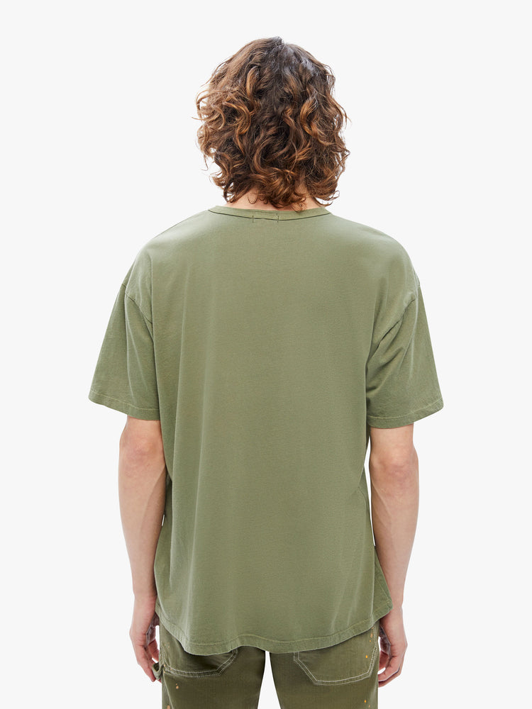 Back view of a mens oversized tee with drop shoulders and a loose fit made from 100% supima cotton in an army-green hue featuring yellow 70s-inspired graphic on the front.