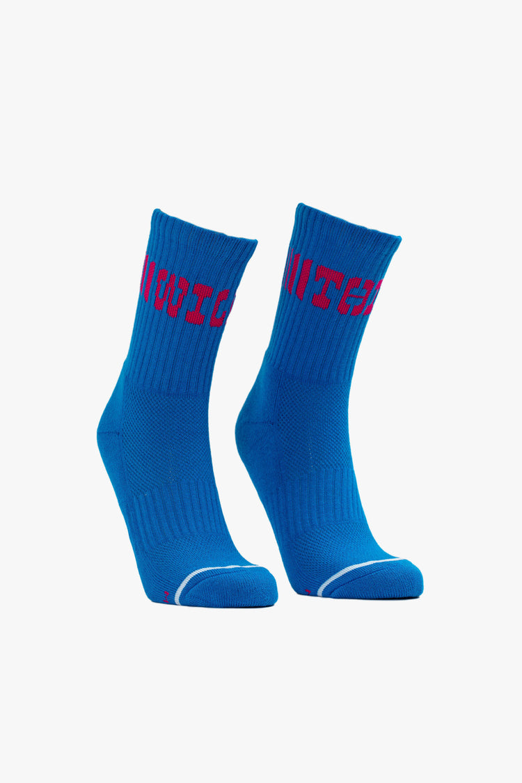 Front view of a royal blue tube sock featuring "WILD THING" in large red western font across the front