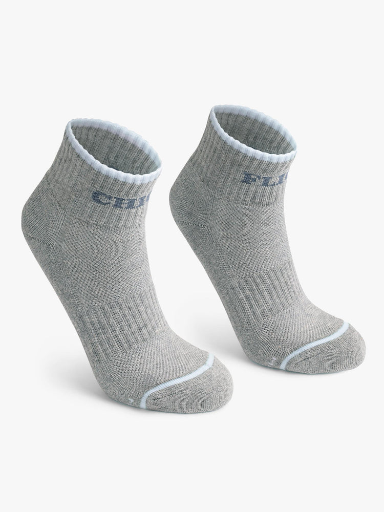 Front view of a pair of grey socks featuring light blue stripes and the words "CHICK" "FLICK".