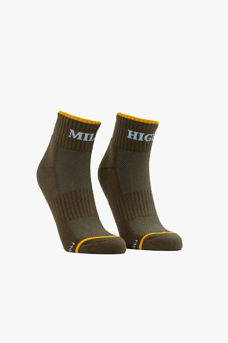 A pair of olive green ankle socks featuring yellow trim and the words "MILE" and "HIGH" in light blue.
