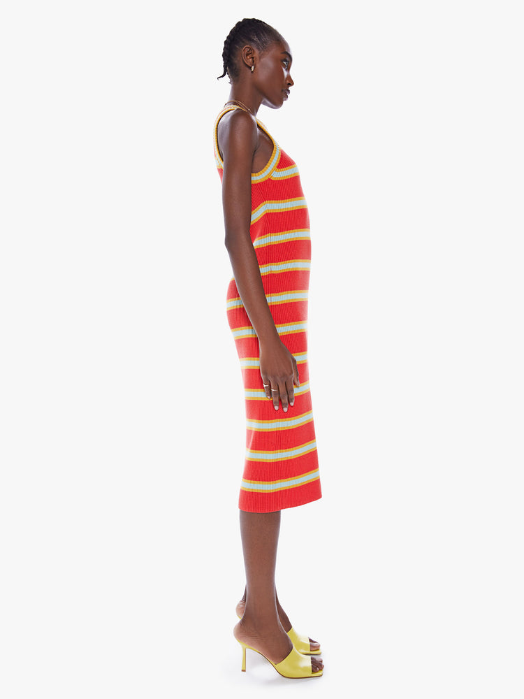 Side view of a woman striped midi dress features a slim fit, racer-style straps and a calf-length hem.