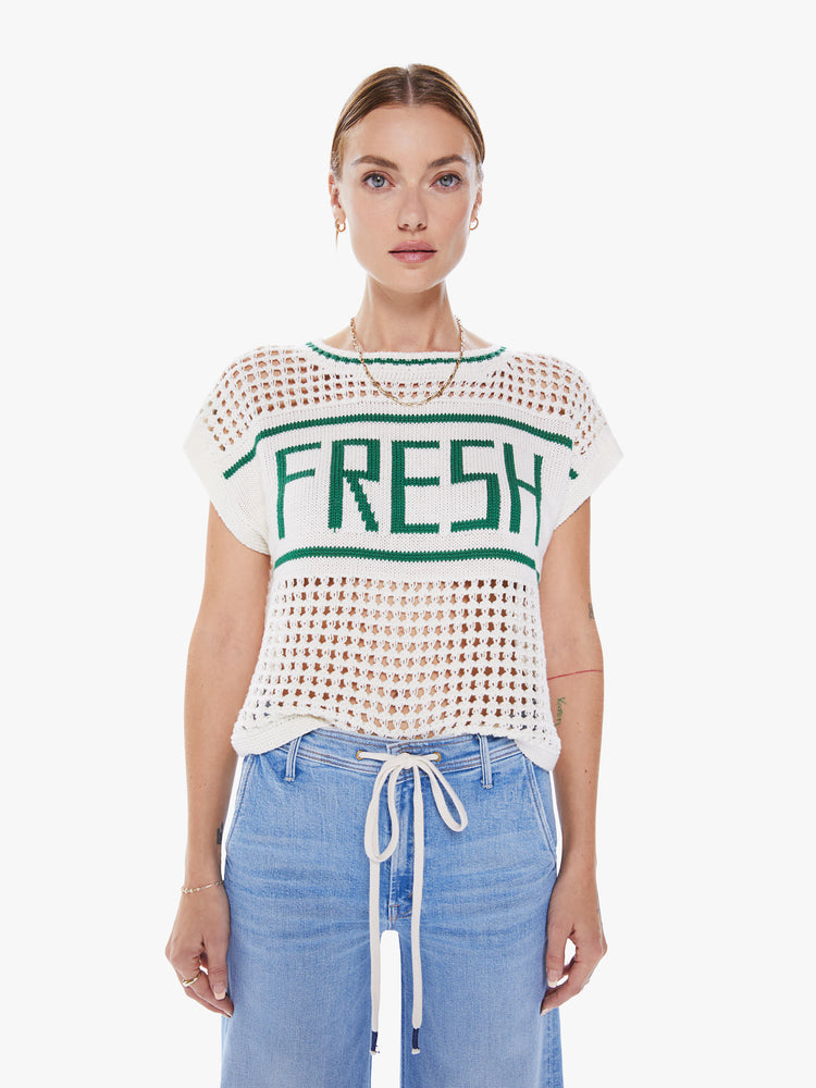 Women's front view a crewneck top with boxy short sleeves and a loose fit in white with green detail with ribbed hems, a chest panel with text and an open-weave knit.