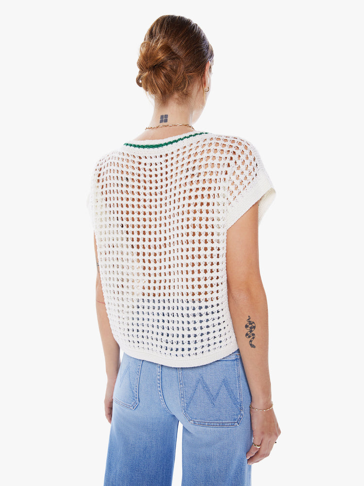 Back view a crewneck top with boxy short sleeves and a loose fit in white with green detail with ribbed hems, a chest panel with text and an open-weave knit.
