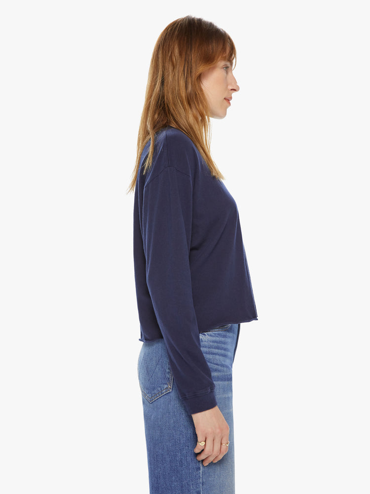 Side view of a womens long sleeve crew neck tee in Navy featuring a cropped raw cut hem.