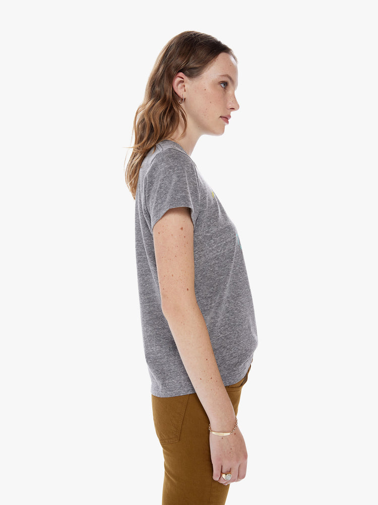 Side view of a woman in a soft crewneck with a slim fit for a vintage look and feel made from a cotton blend in a heathered grey hue, the tee features a faded cobra snake graphic in red and paint smears on the front