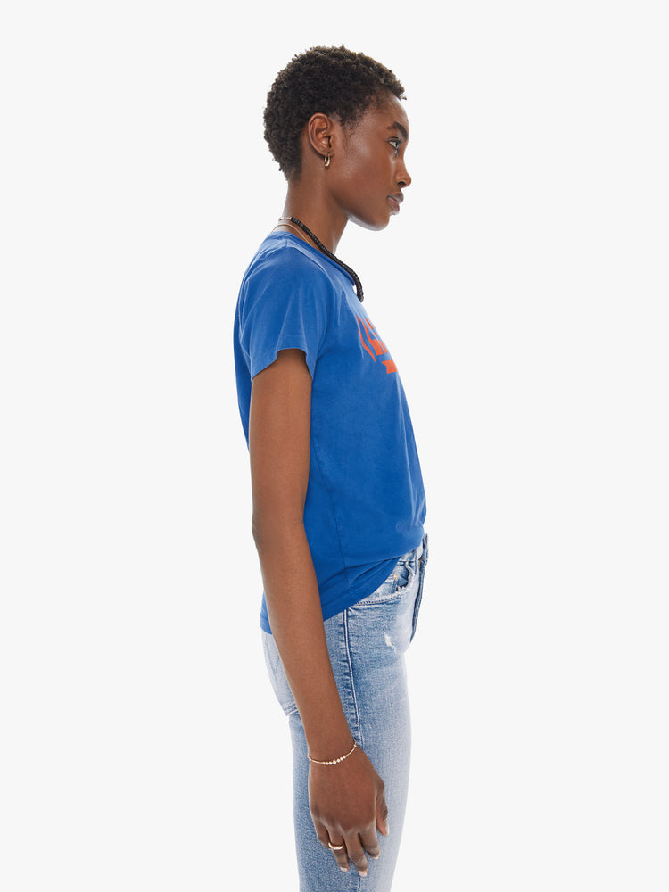 Side view of a womens blue crew neck tee featuring a fitted body and a red graphic reading "LE CHATEAU".