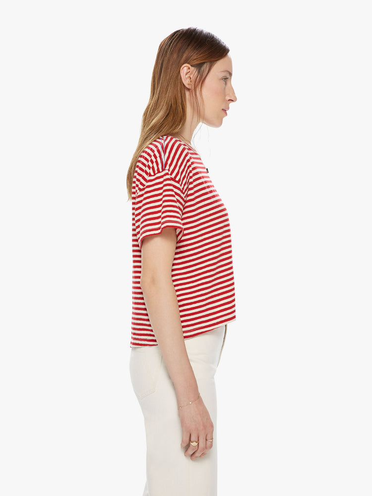 Side view of a red a white striped crew neck tee featuring dropped shoulders and a boxy cropped fit.