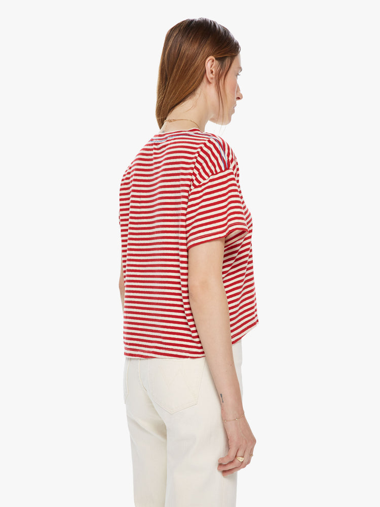 Back view of a red a white striped crew neck tee featuring dropped shoulders and a boxy cropped fit.